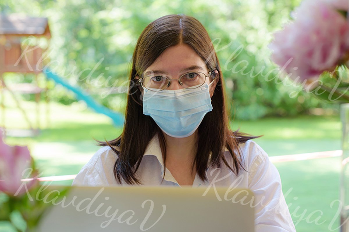 works at a laptop on the summer veranda example image 1