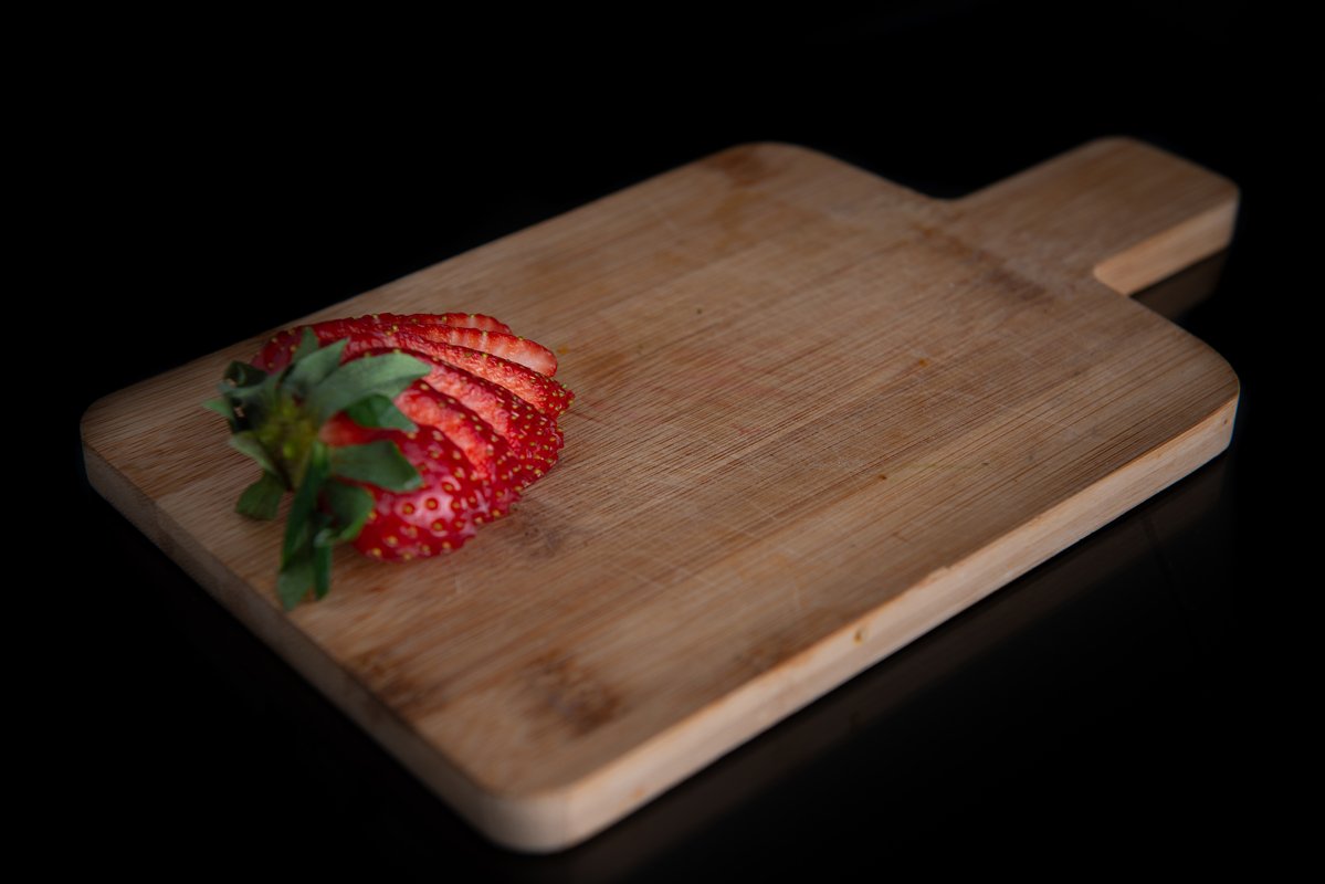 sliced strawberry on a wooden board with a place for text example image 1