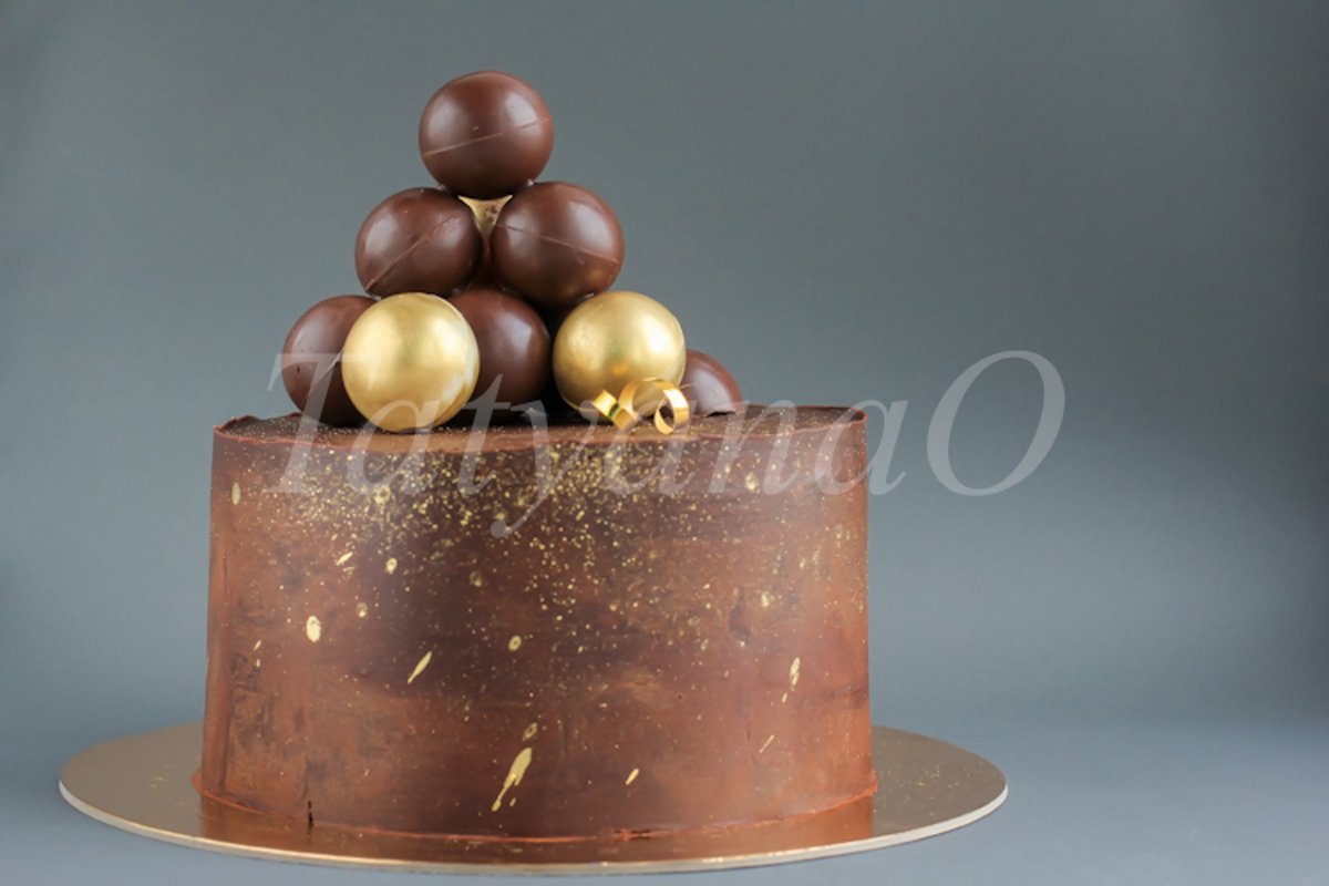 Chocolate birthday cake with gold decorations. example image 1