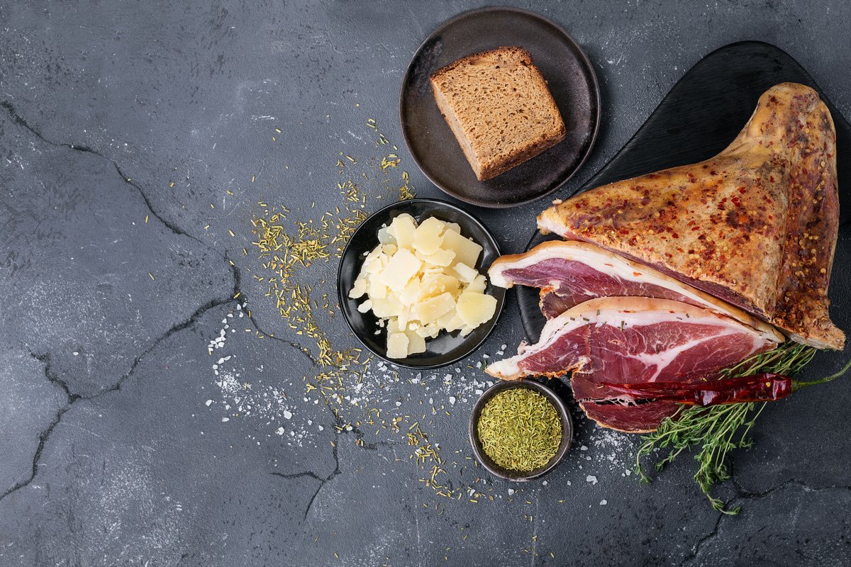 Prosciutto Ham served on a rustic wooden board example image 1