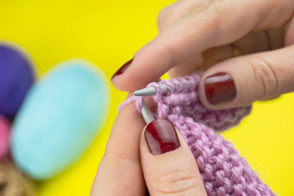 the girl knits a children's scarf on a yellow background example image 1