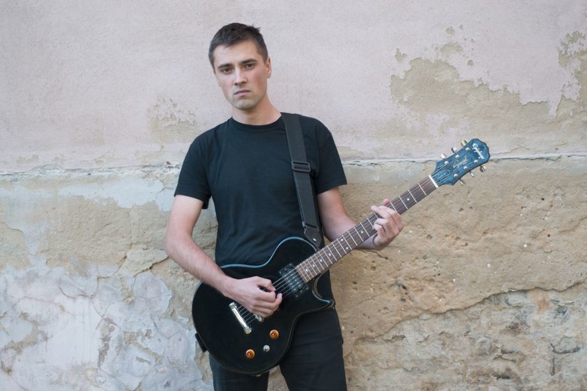 Young caucasian man with electric guitar example image 1