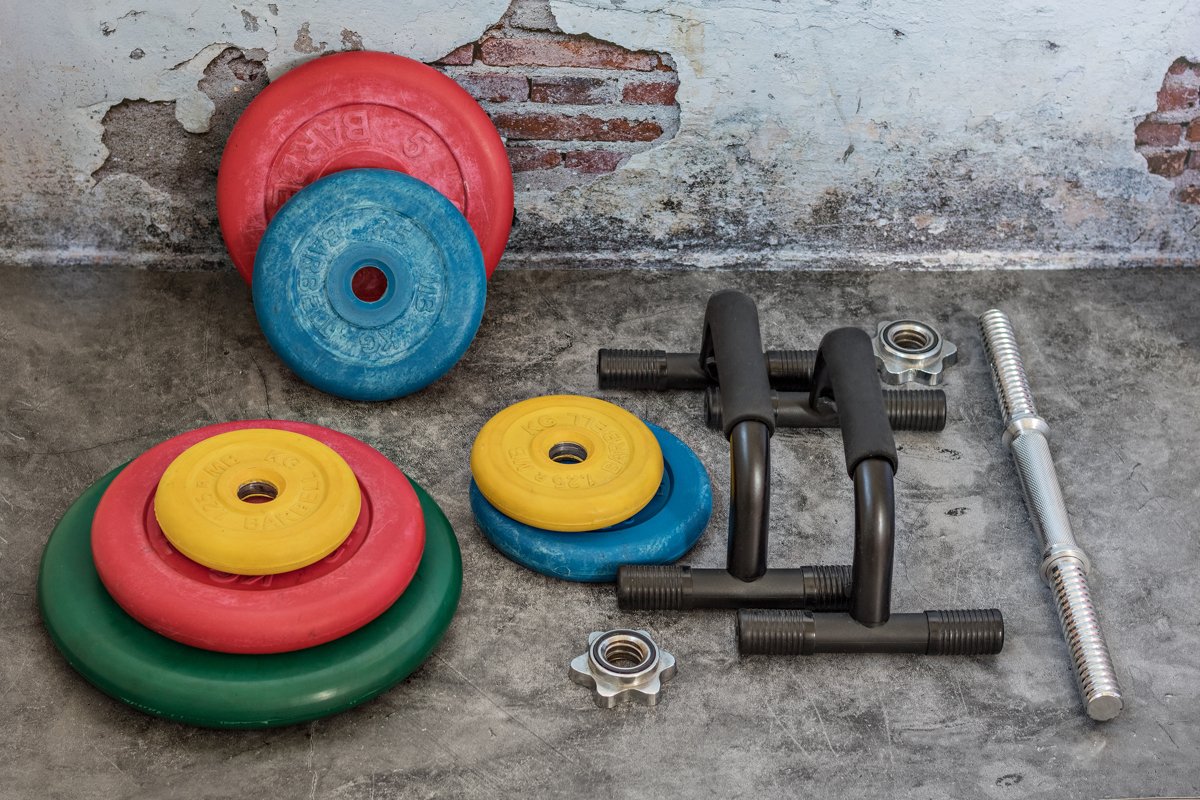 Professional dumbbells and multi-colored weight plates on a example image 1