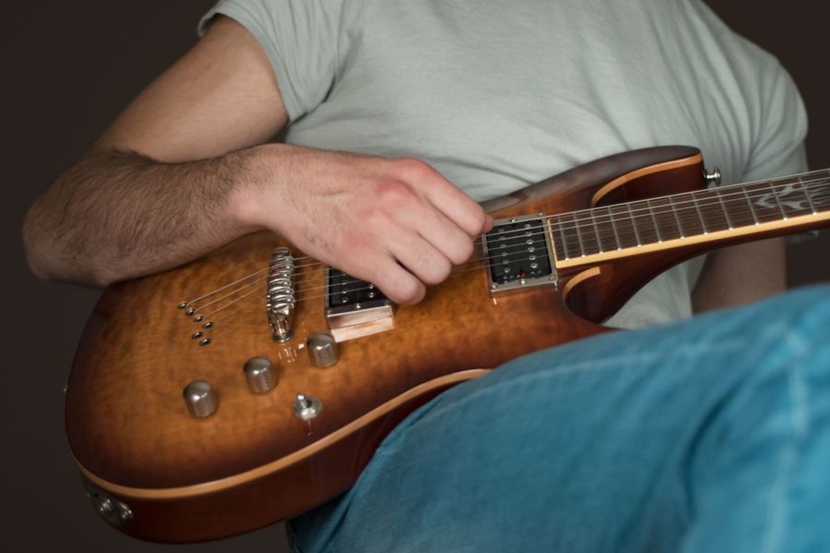 Man plays on electric guitar in studio example image 1