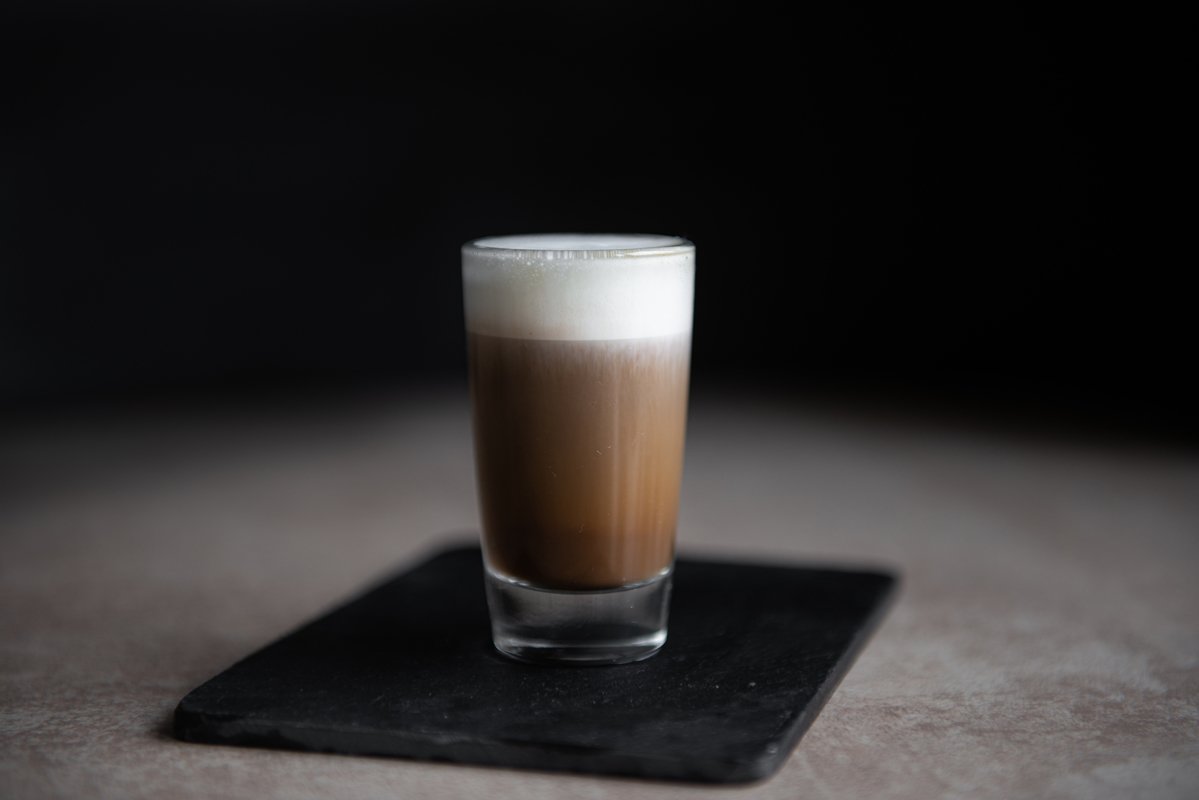 mini cup of cappuccino in a glass cup on black background example image 1