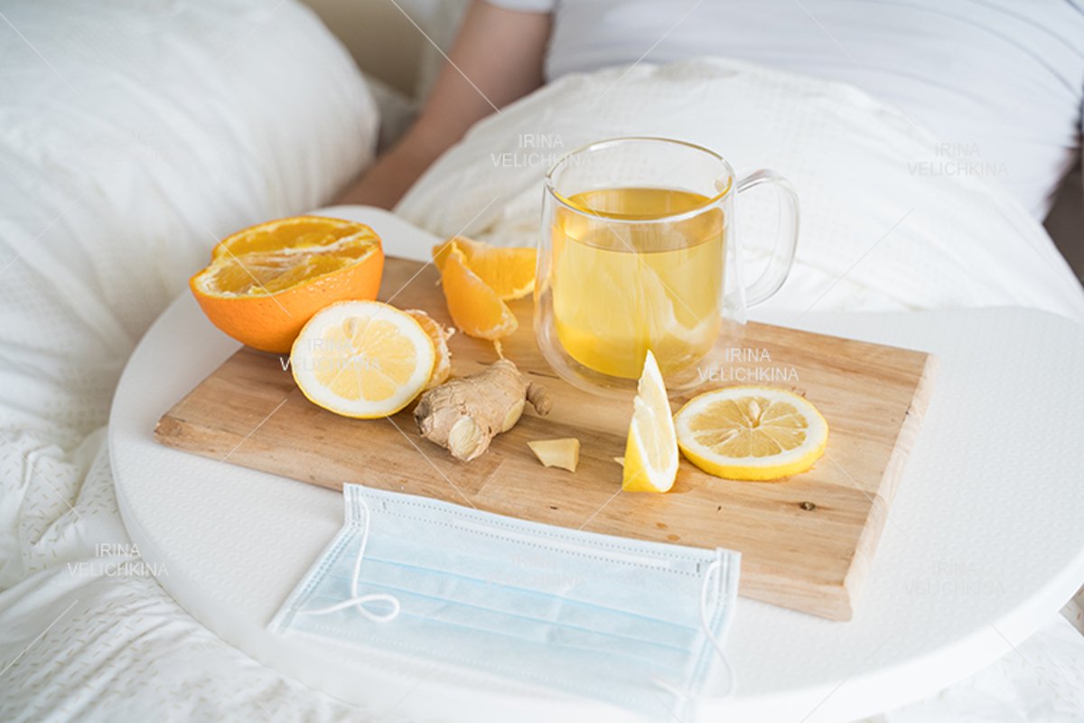 Cup of tea, orange,lemon,ginger. Face mask. Sick man in bed example image 1