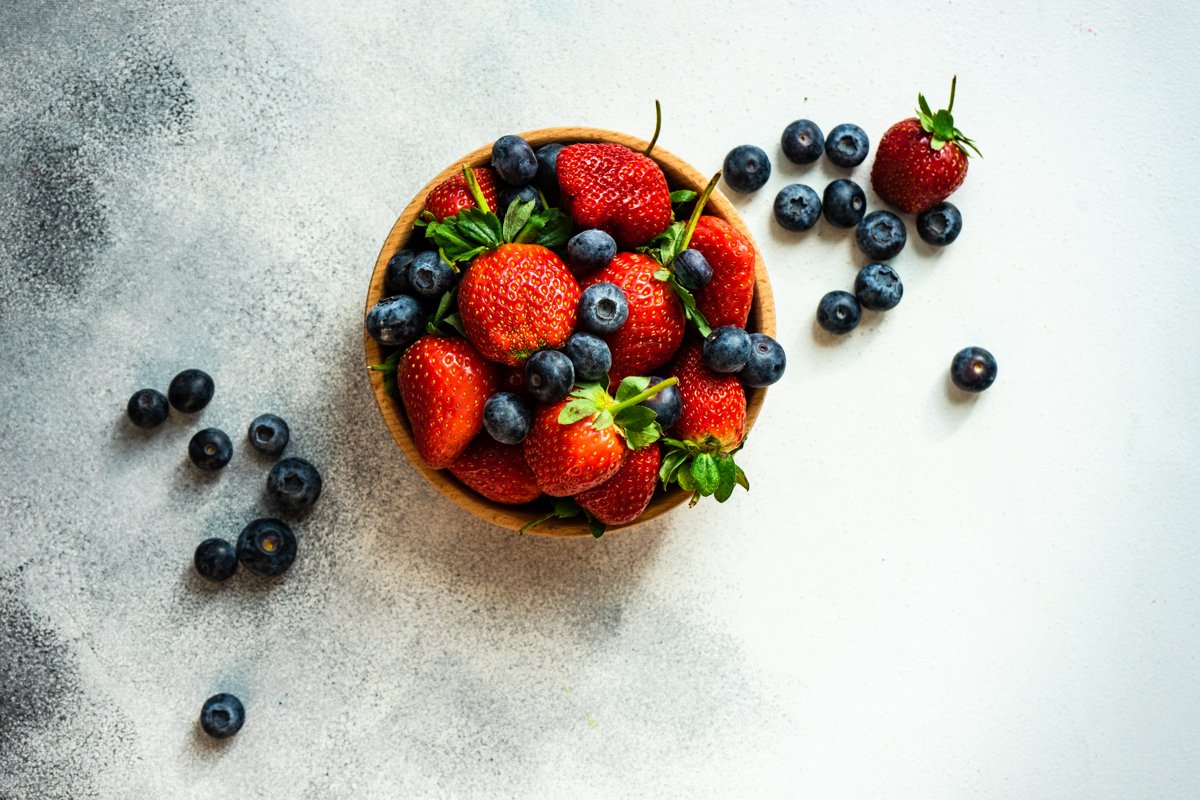 Organic summer berries in wooden bowl full of strawberries example image 1