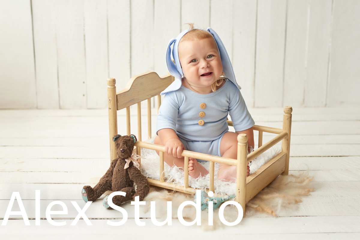Easter Baby boy sitting on crib. Easter bunny. example image 1