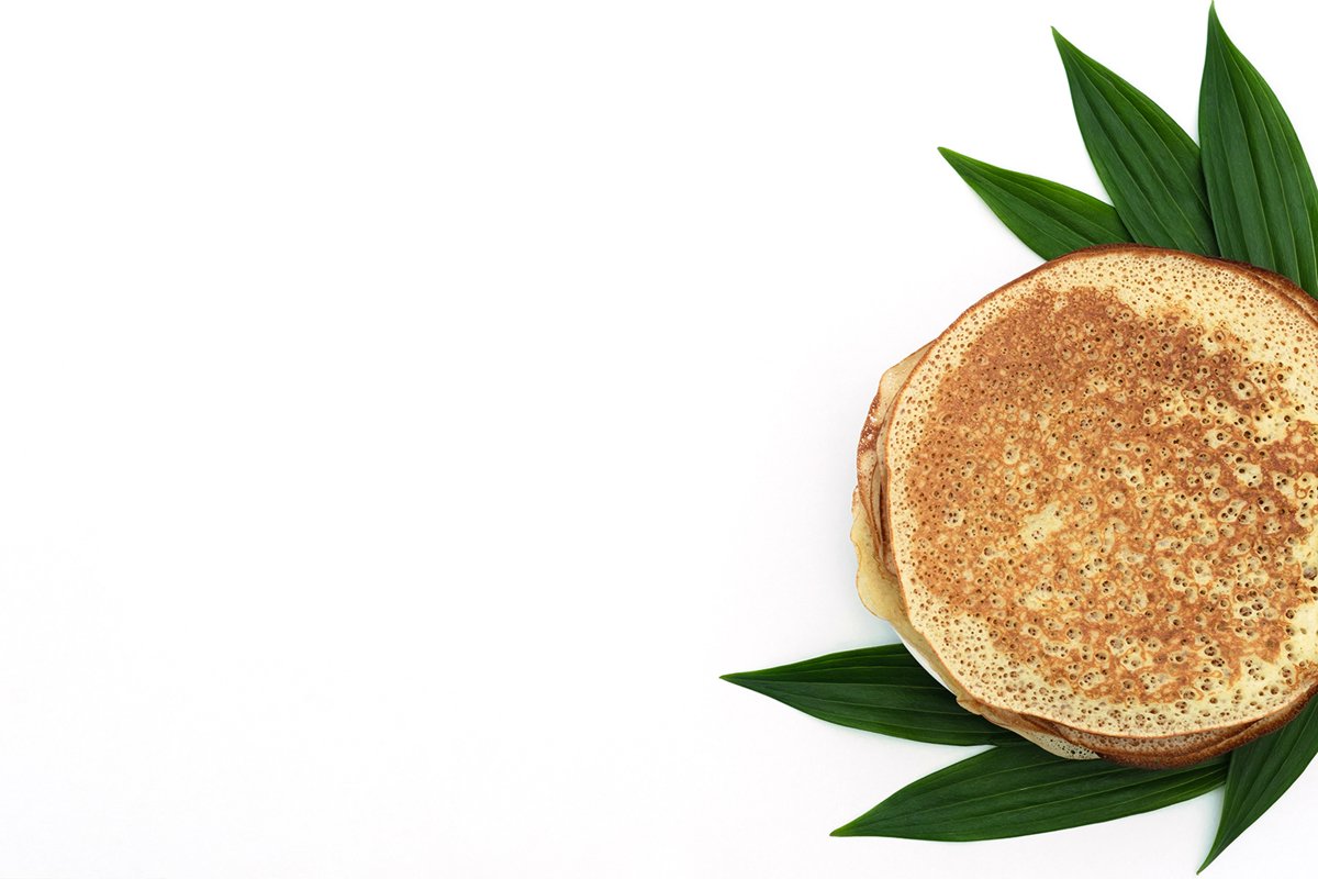 Homemade pancakes on white background with green leaves example image 1