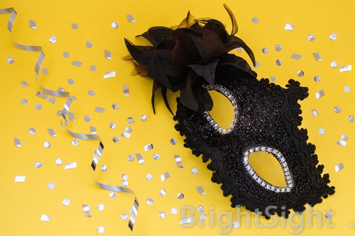 Black carnival mask on yellow background example image 1