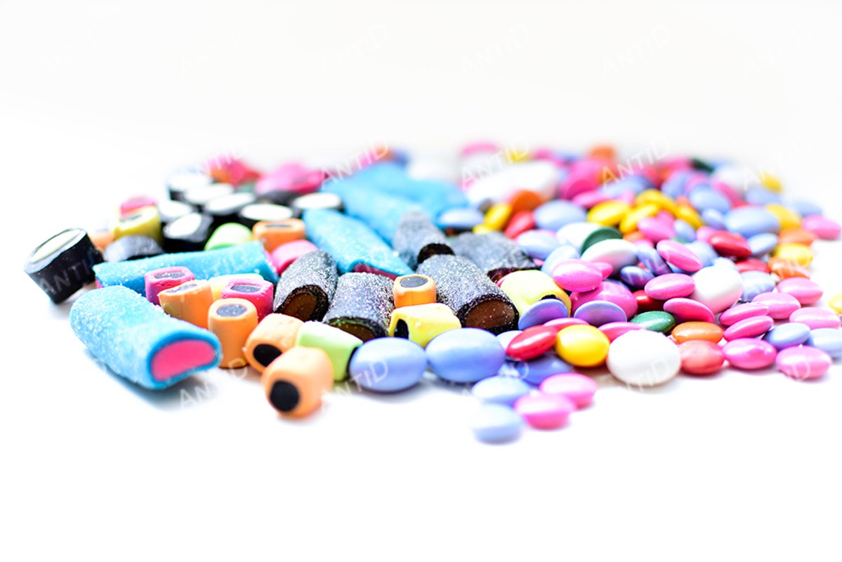 Multicolored candy on a white background. example image 1