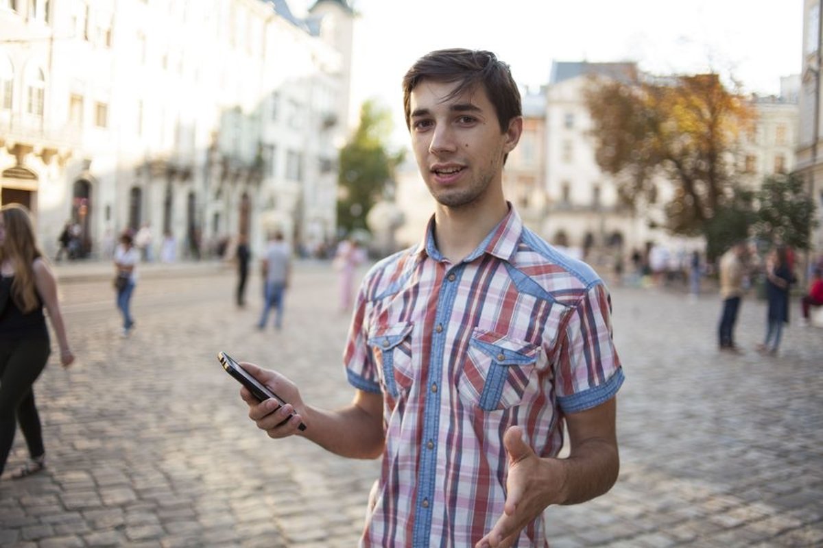 Young man walks in the city example image 1