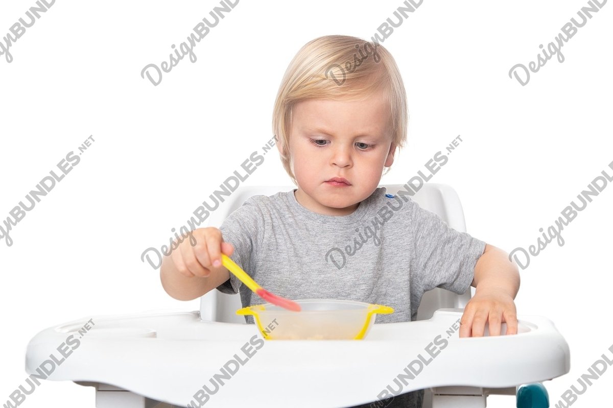 Cute boy with a spoon in his hand on the white background example image 1