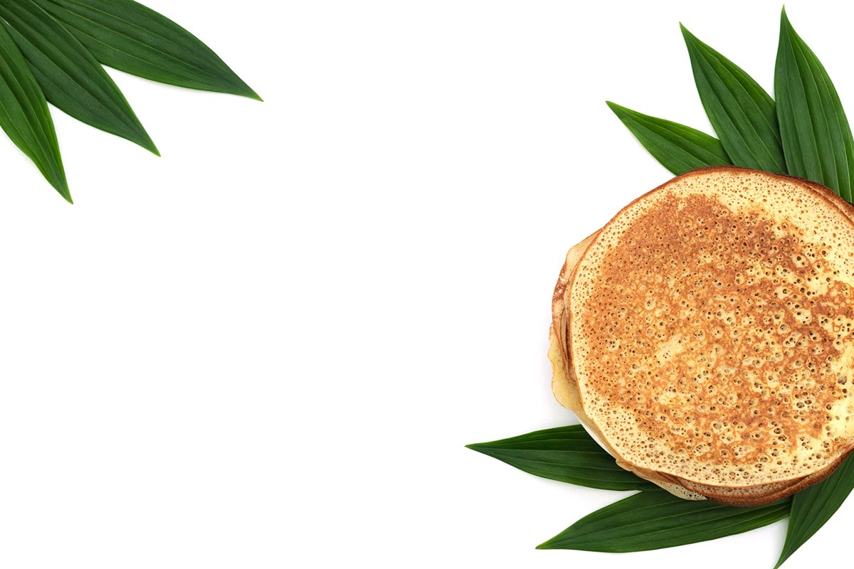 Homemade pancakes on white background with green leaves example image 1