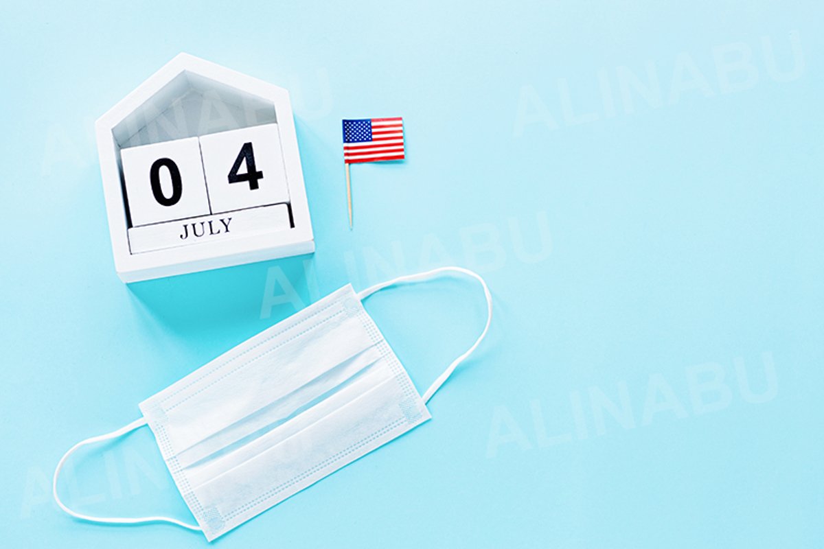 July 4th. USA flag and medical mask on blue background example image 1
