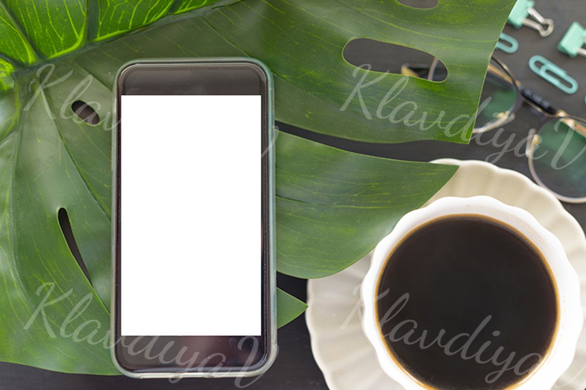 a smartphone with an empty screen and a Cup of coffee example image 1