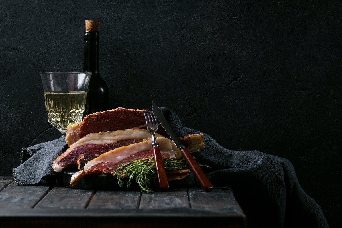 Prosciutto Ham served on a rustic wooden board example image 1