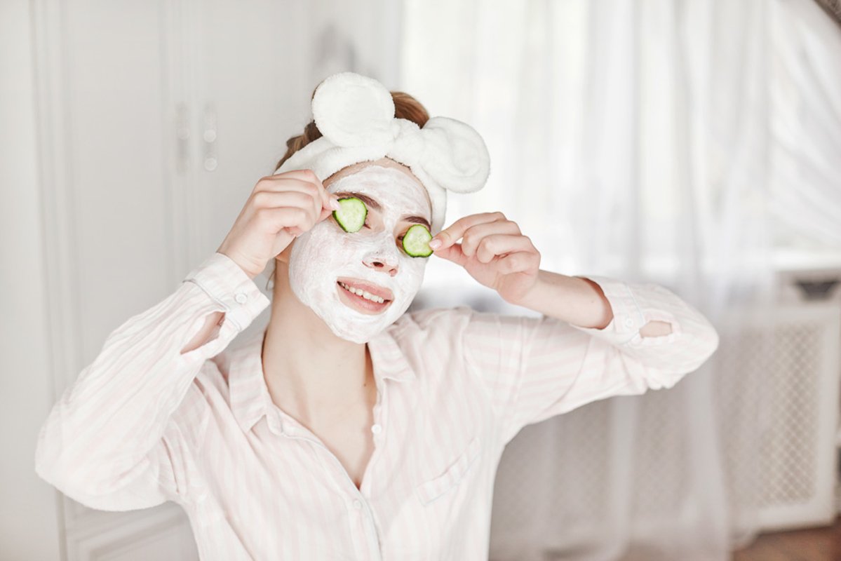 Girl with a face mask and slices of cucumber example image 1