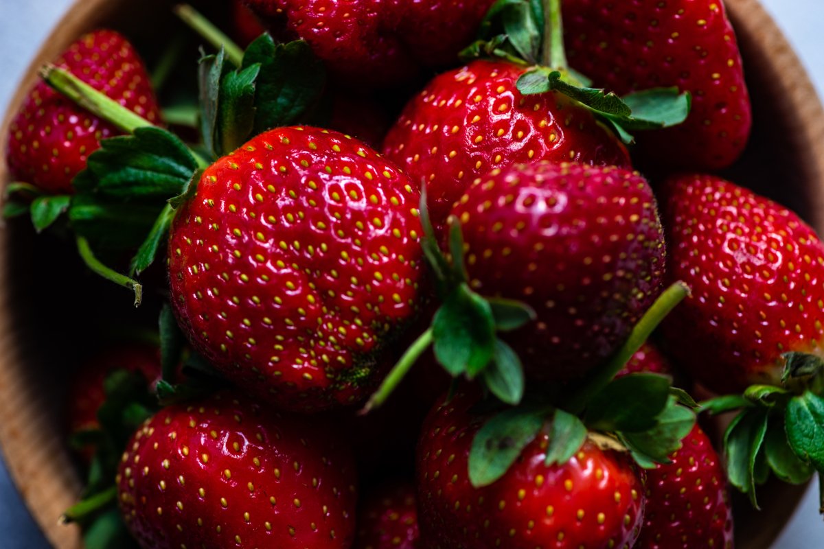 Organic summer berries in wooden bowl full of strawberries example image 1