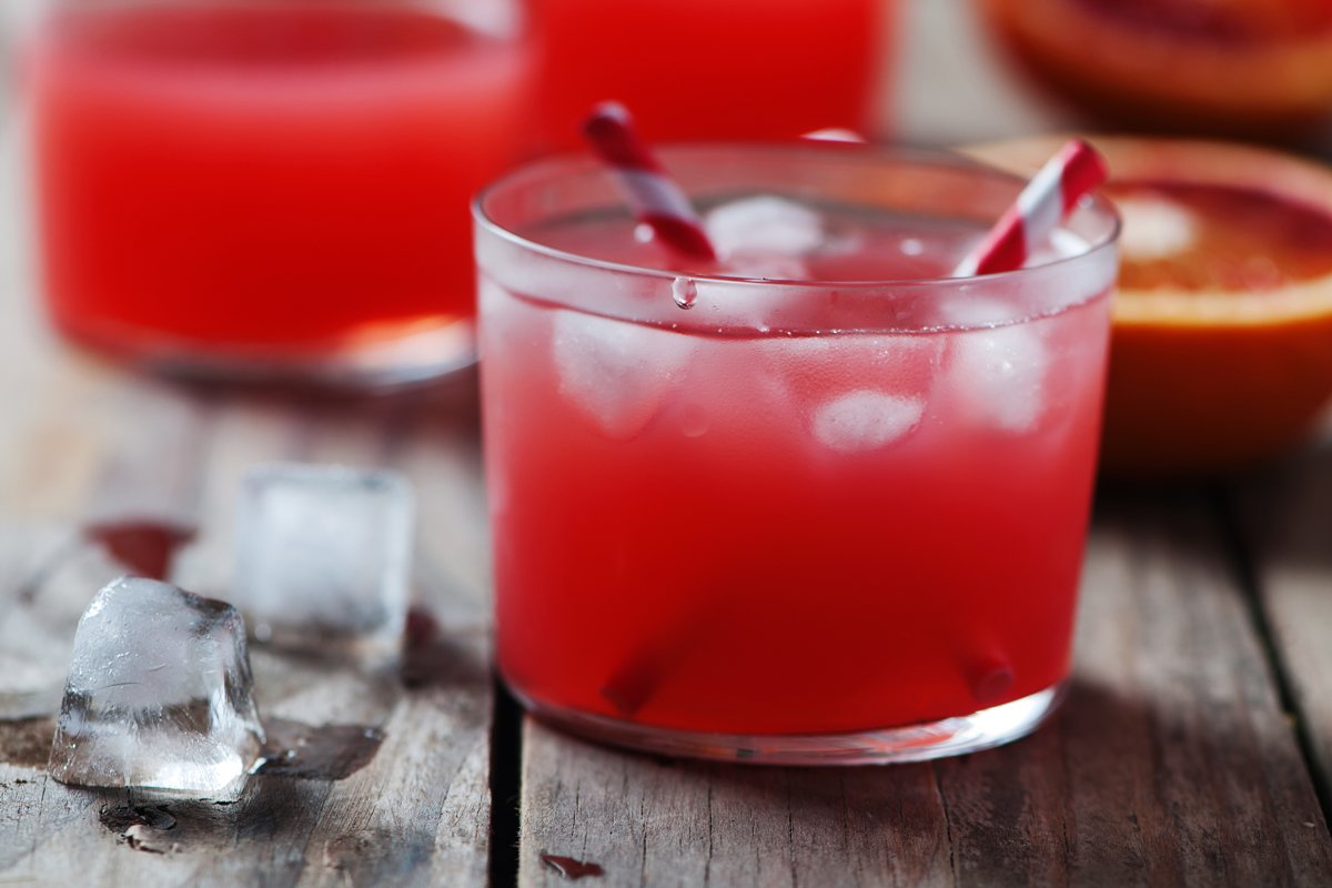 Fresh red orange juice in a glass, selective focus example image 1