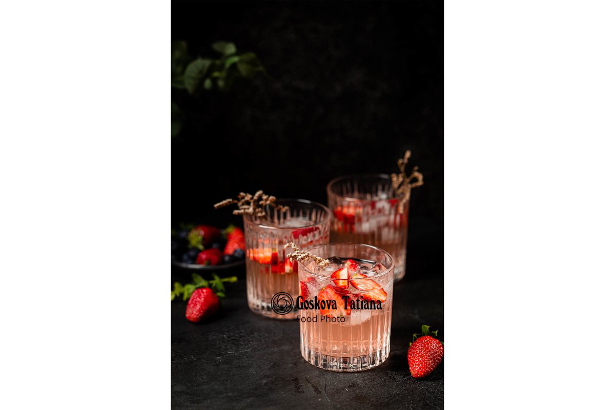 Photo of Cold fresh pink lemonade drink with ice in a glass example image 1