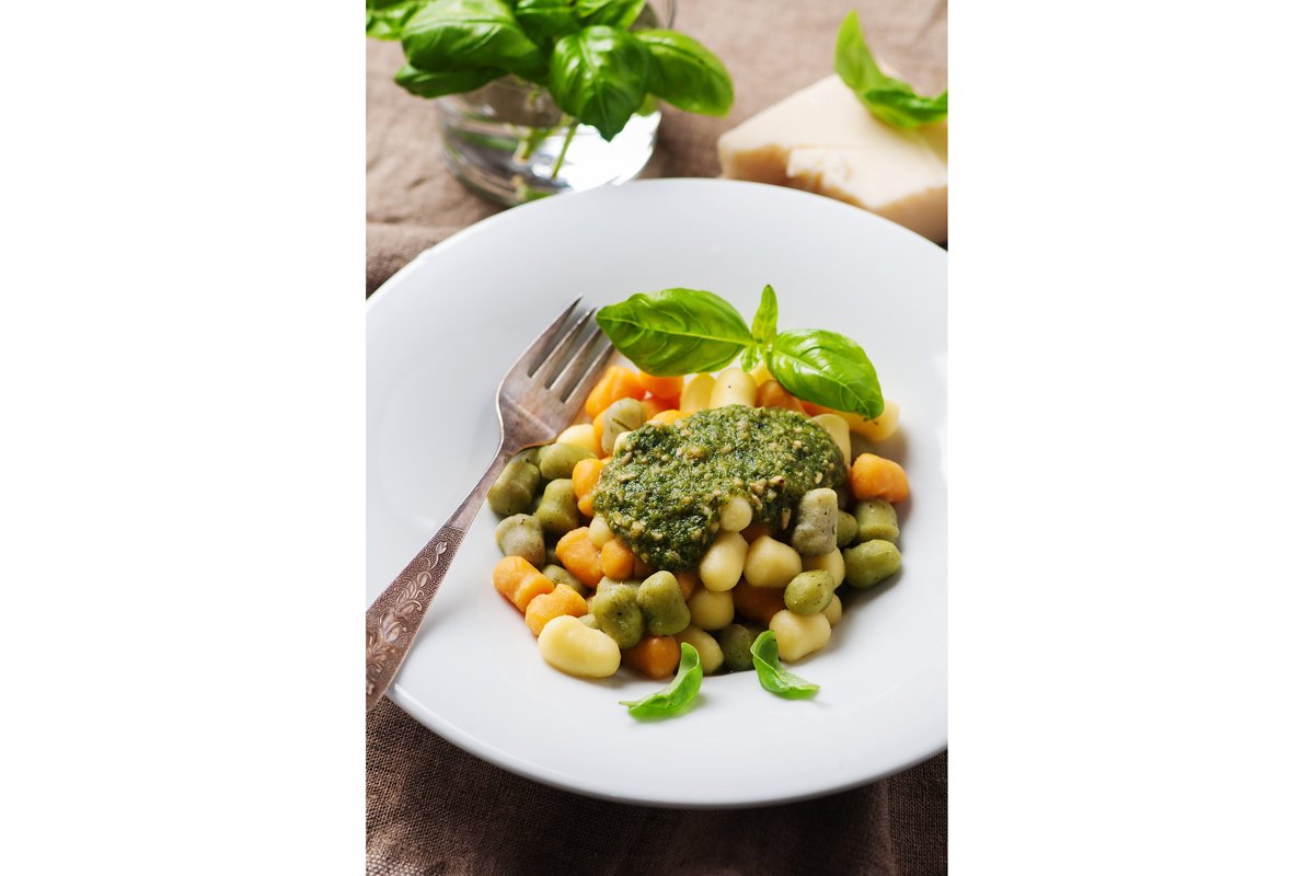 Colored gnocchi with pesto, selective focus example image 1
