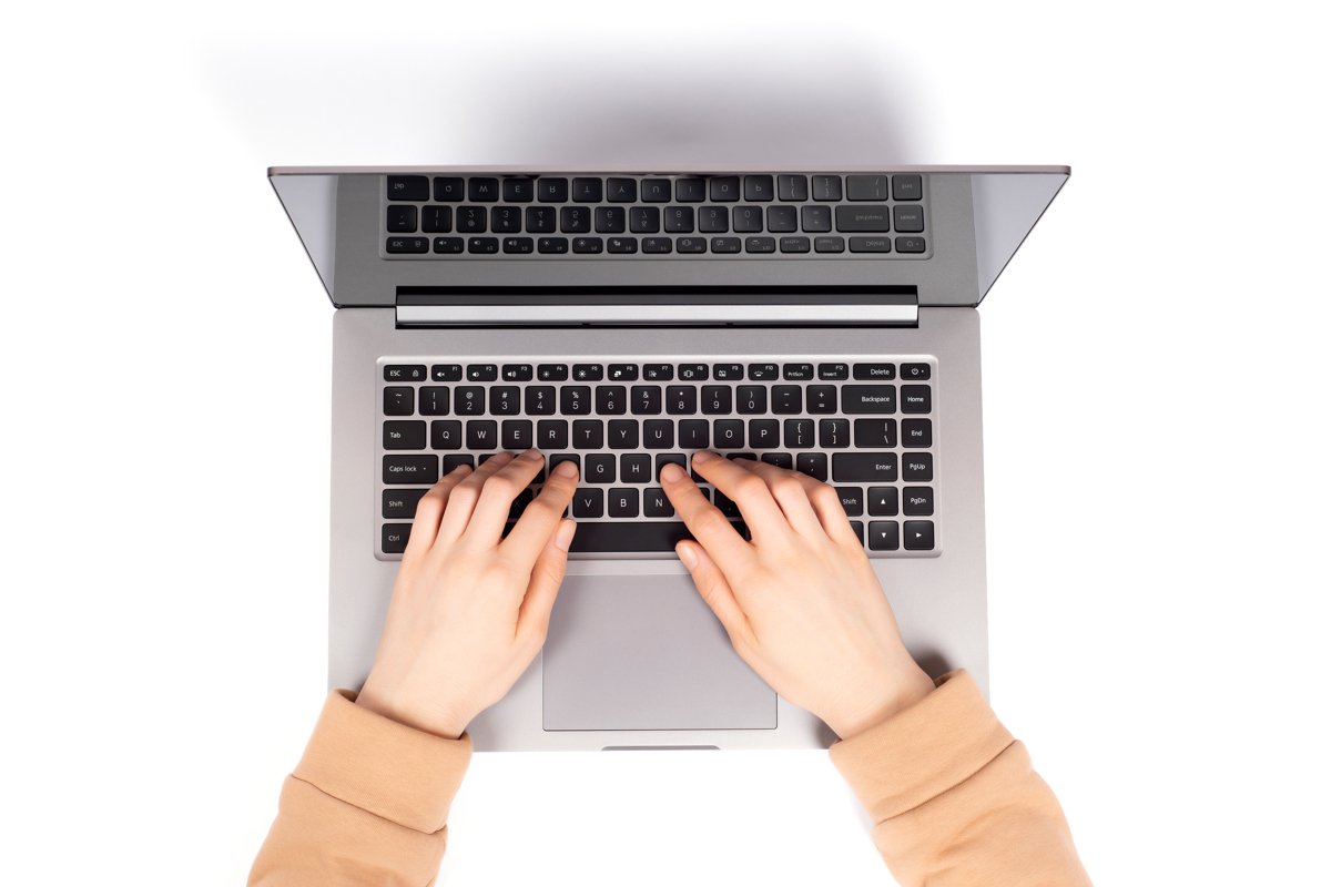Person working on a laptop computer in a modern space. example image 1