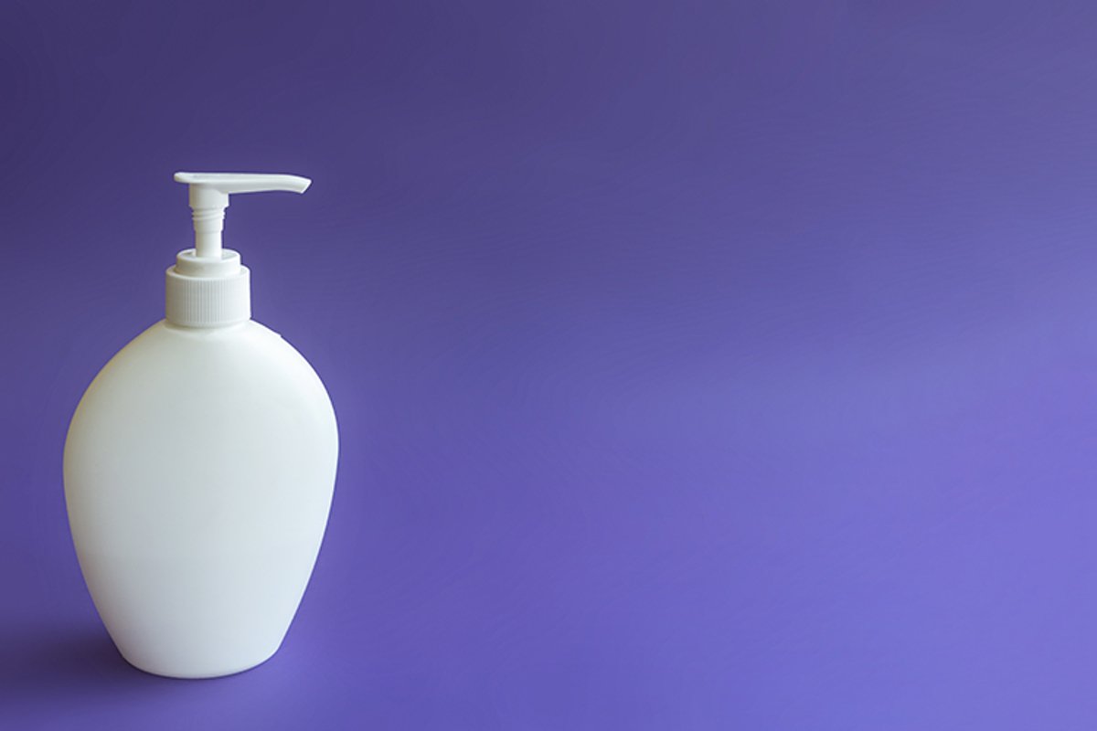 Empty bottle layout with a dispenser on a purple background. example image 1