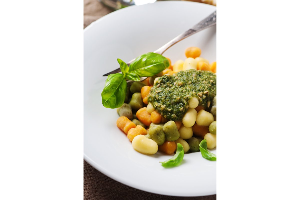 Colored gnocchi with pesto, selective focus example image 1