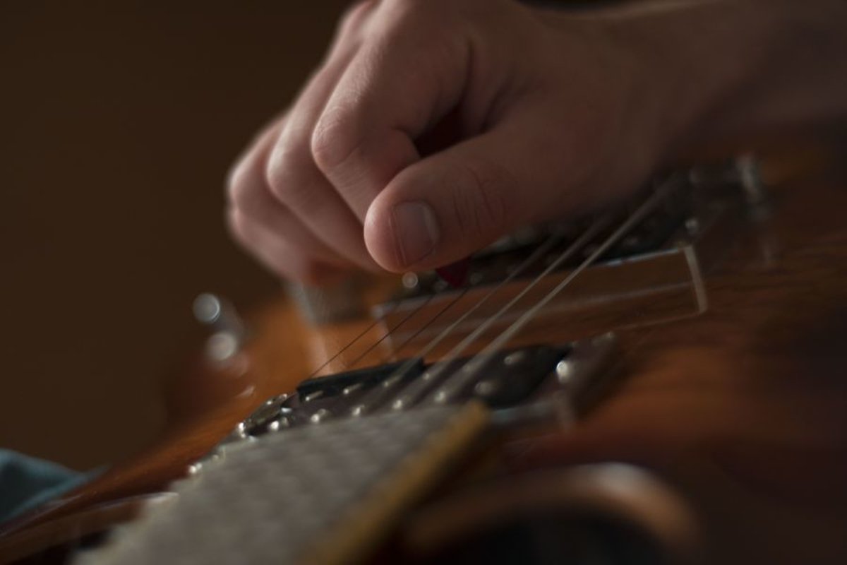 Man plays on electric guitar in studio example image 1
