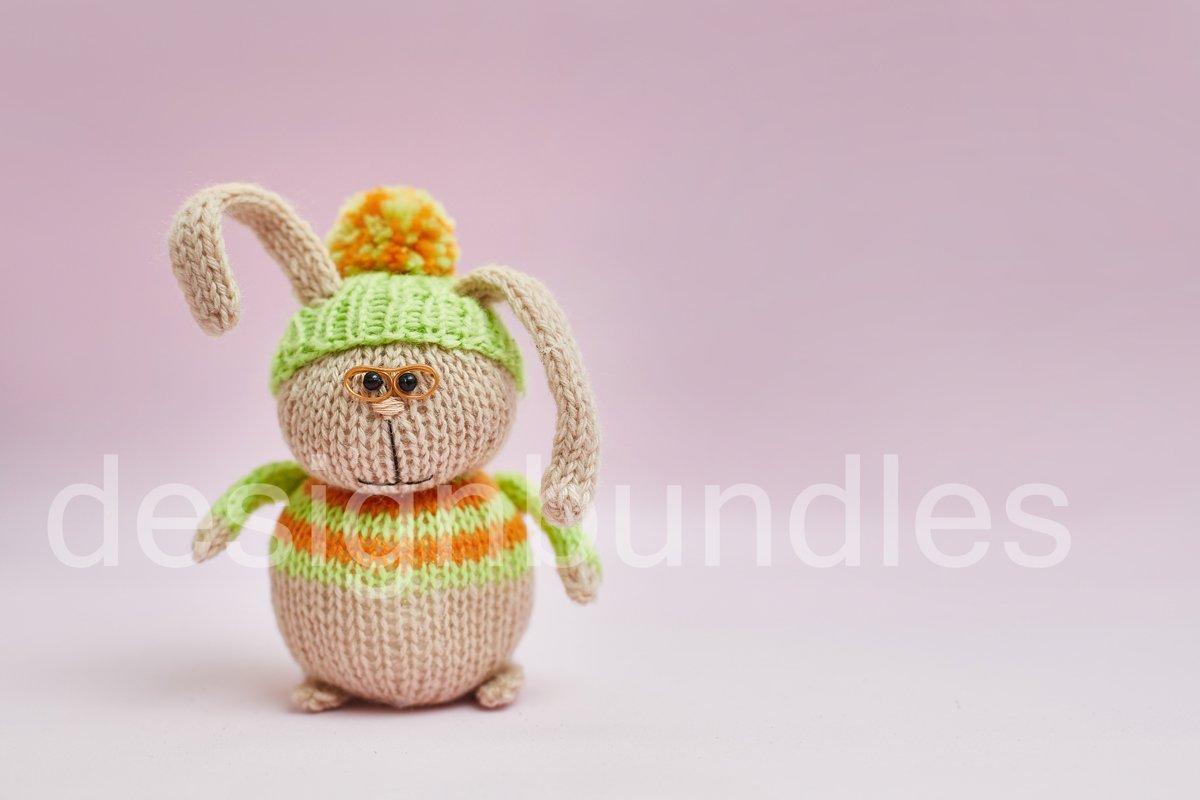Toy rabbit in glasses on a pink background. example image 1