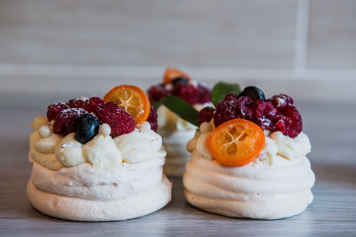 Pavlova meringue cake with cream and small fruits example image 1