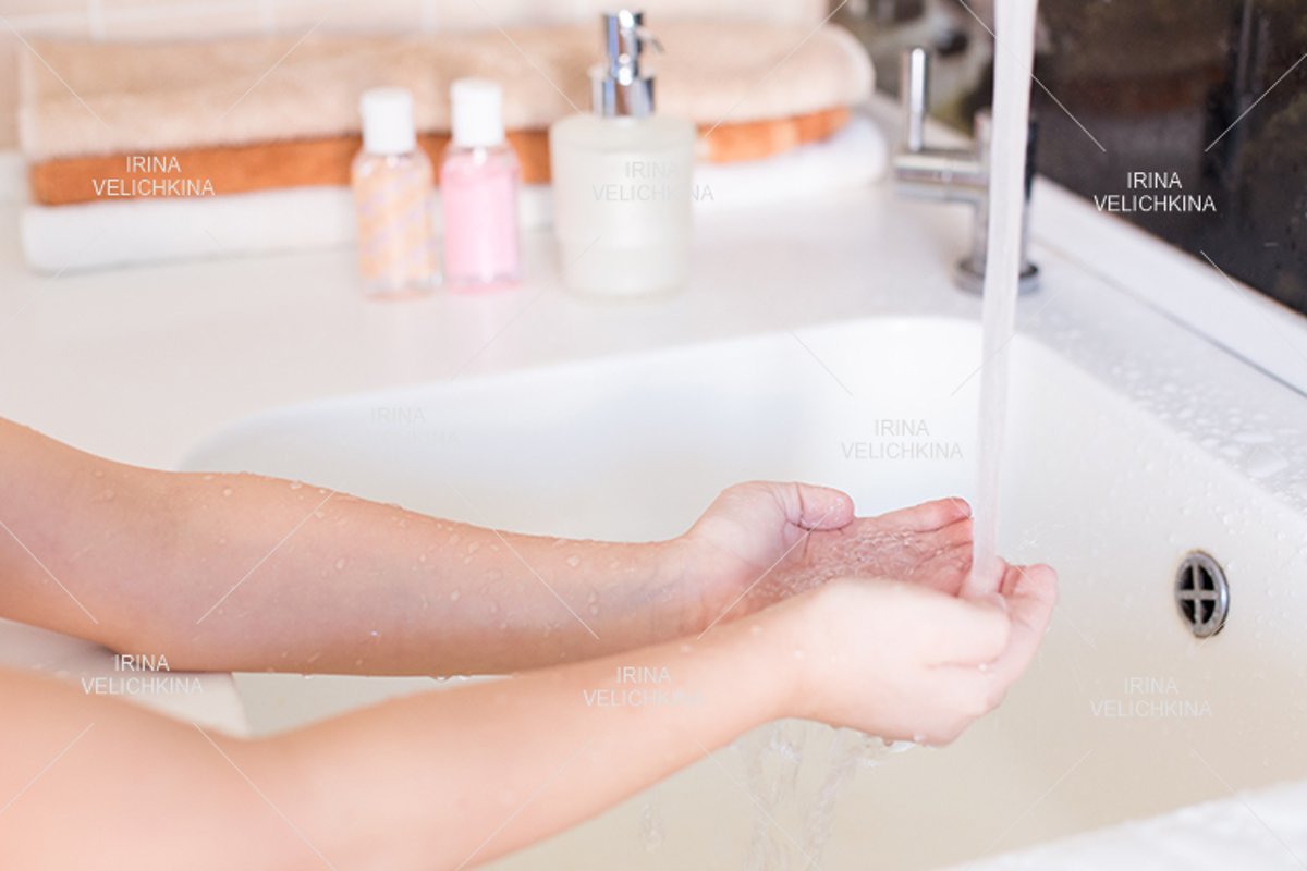 Girls wash their hands in the sink with soap in the foam example image 1