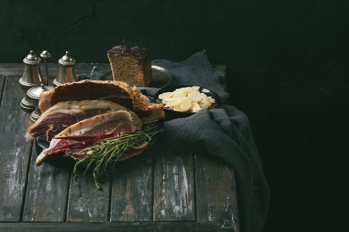 Prosciutto Ham served on a rustic wooden board example image 1