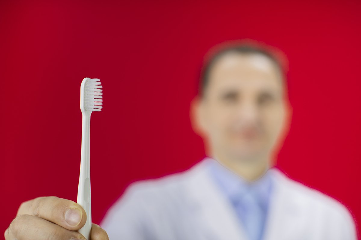 Doctor therapist with a stethoscope on a red background example image 1