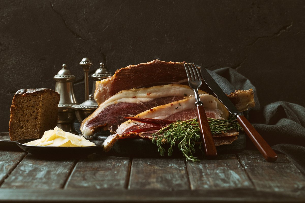Prosciutto Ham served on a rustic wooden board example image 1