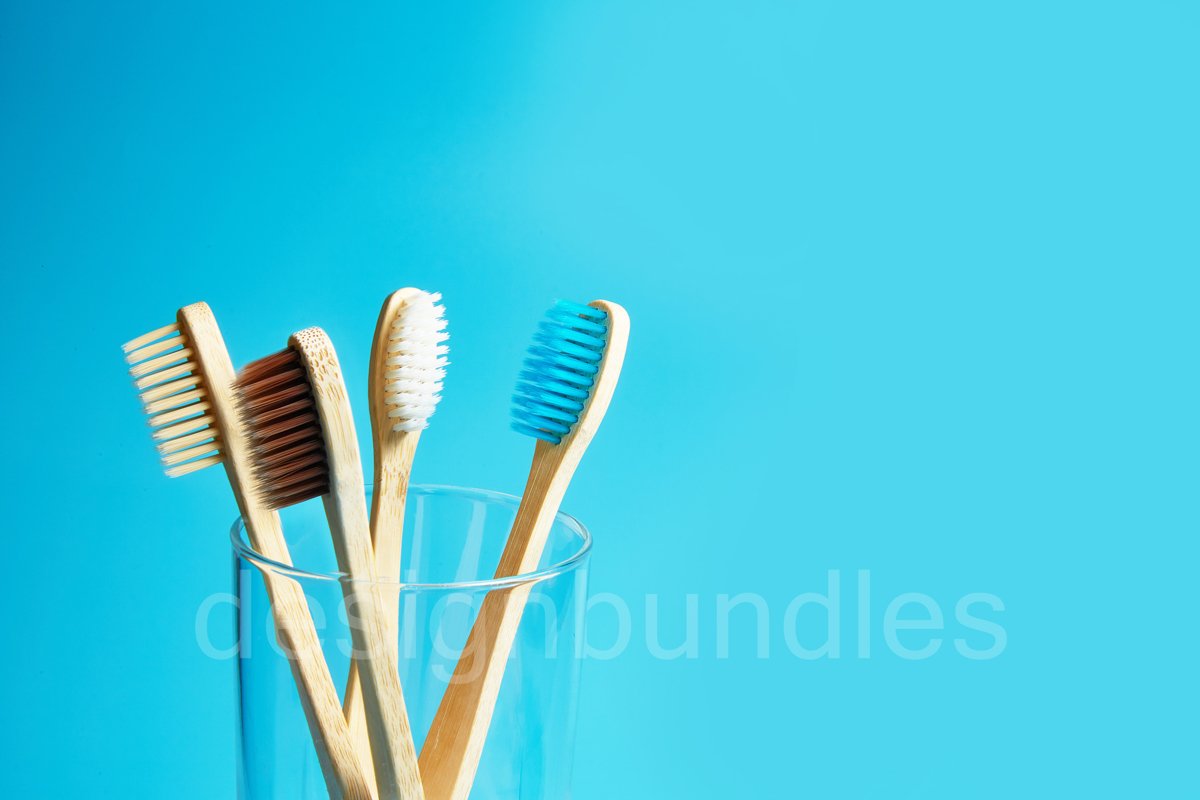 Wooden toothbrushes with a glass cup on a blue background example image 1