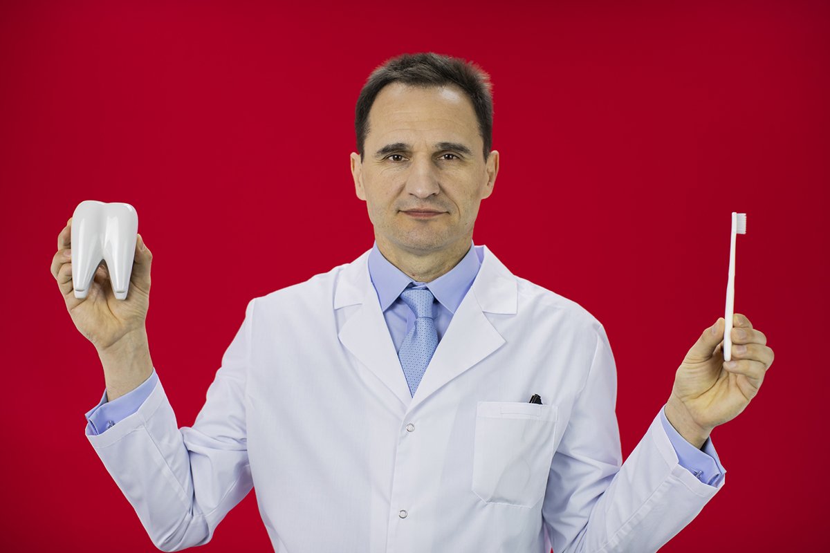 Doctor therapist with a stethoscope on a red background example image 1