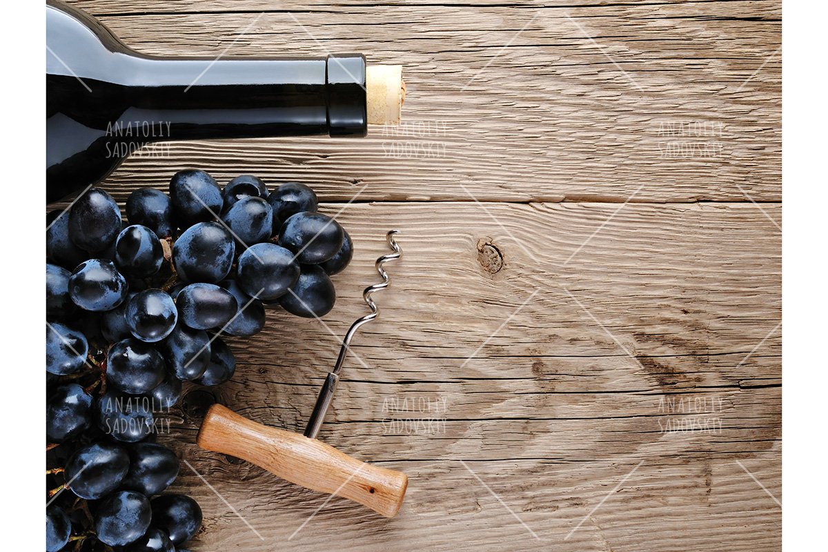 Bottle of wine, corkscrew and grape on wooden background example image 1