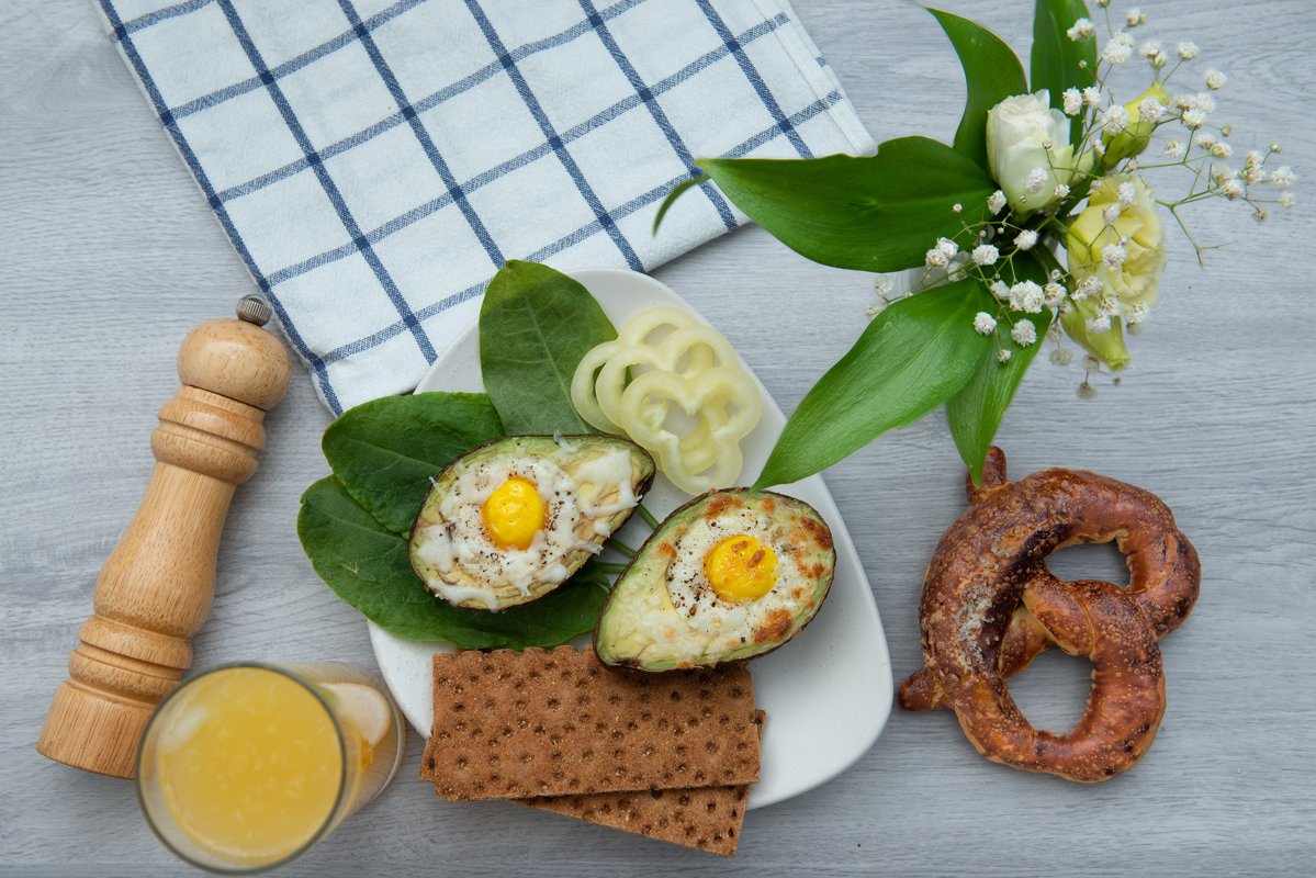 flat lay eggs baked in avocado on plate example image 1