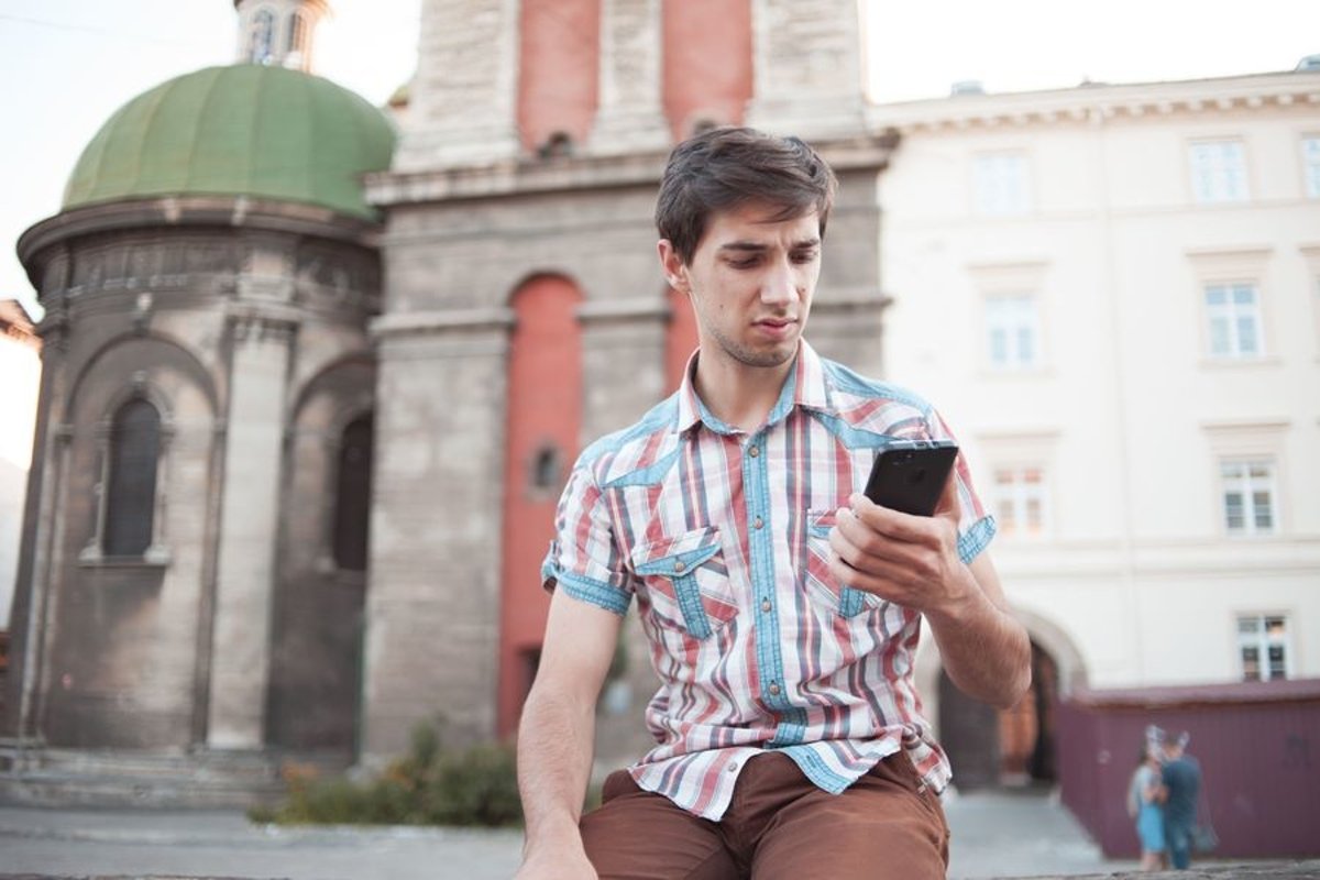 Young man walks in the city example image 1