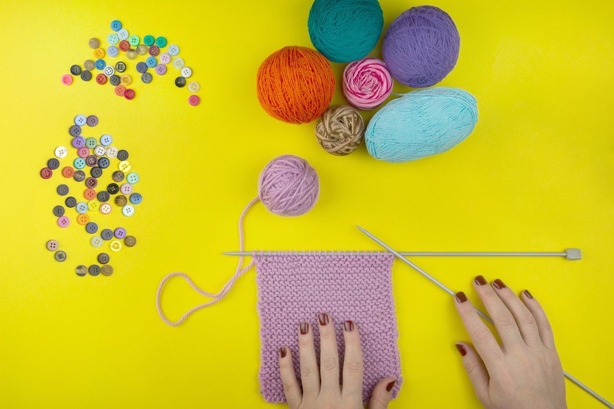the girl knits a children's scarf on a yellow background example image 1