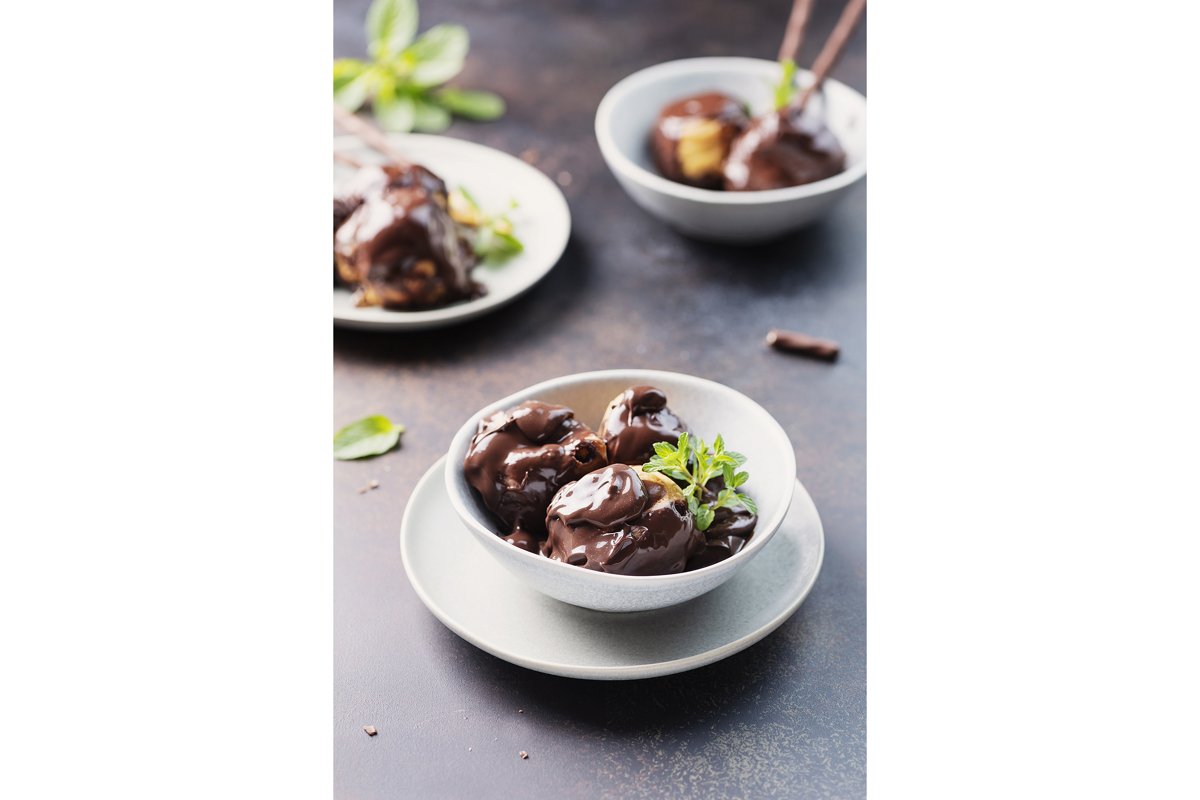 Traditional italian dessert profiteroles with chocolate example image 1