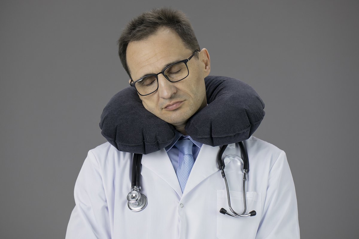 Doctor therapist with a stethoscope on a gray background example image 1