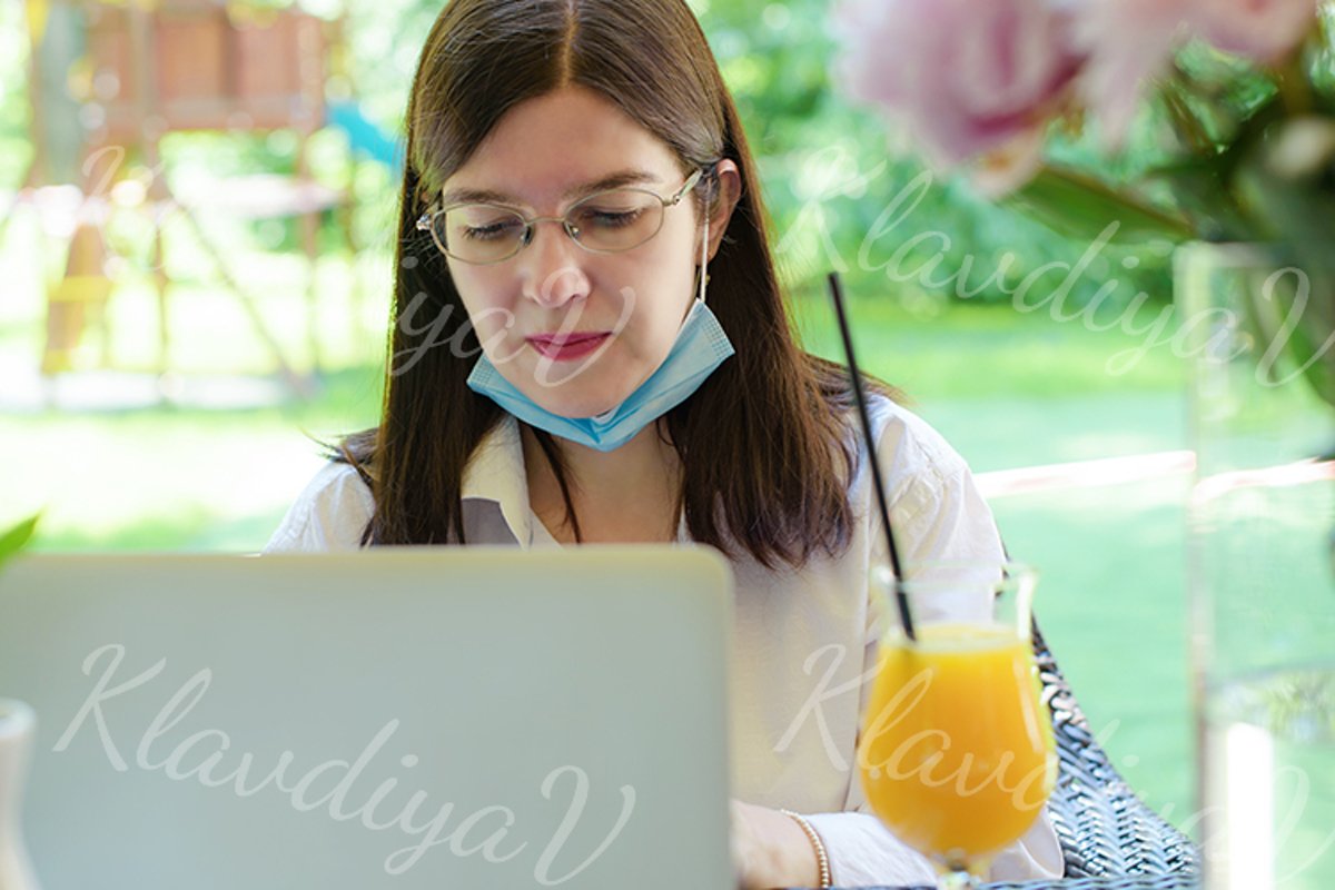 works at a laptop on the summer veranda example image 1