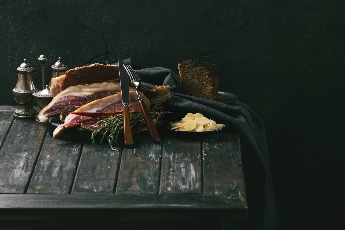 Prosciutto Ham served on a rustic wooden board example image 1