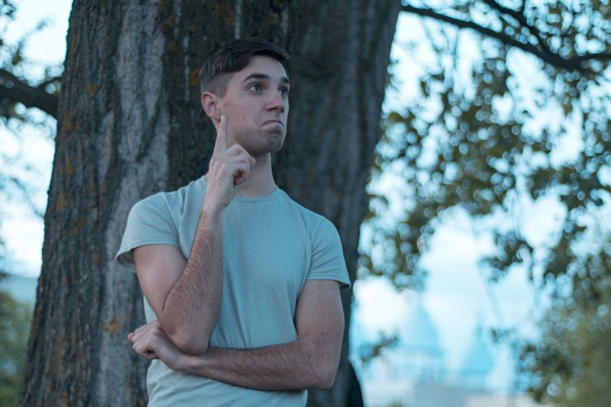 Young caucasian man walks in a park example image 1