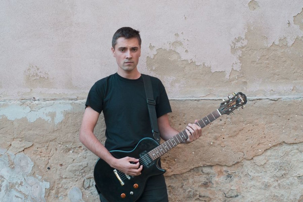 Young caucasian man with electric guitar example image 1