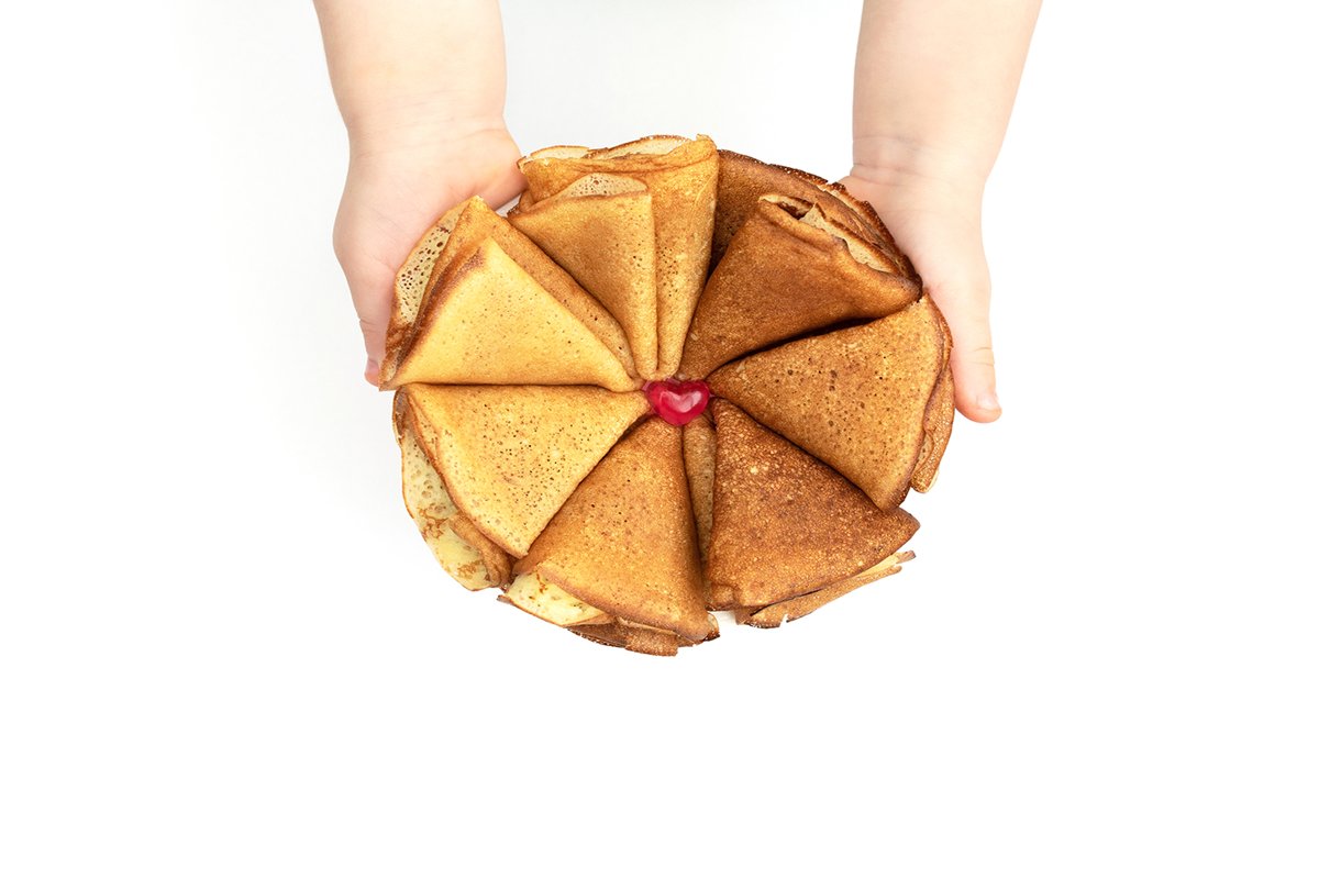 The flower made of homemade pancakes in childs hands example image 1