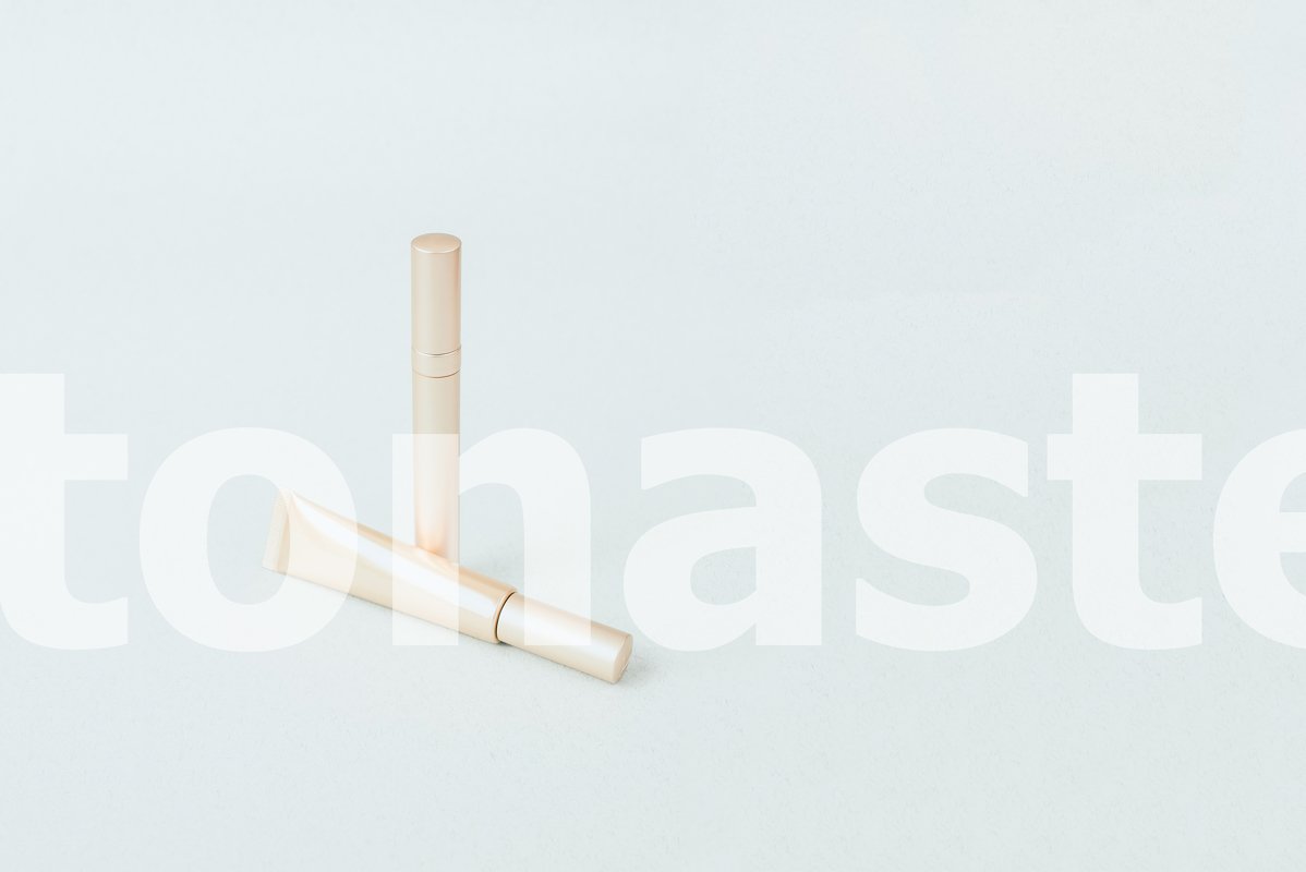 Different golden mascara on a pastel blue background example image 1